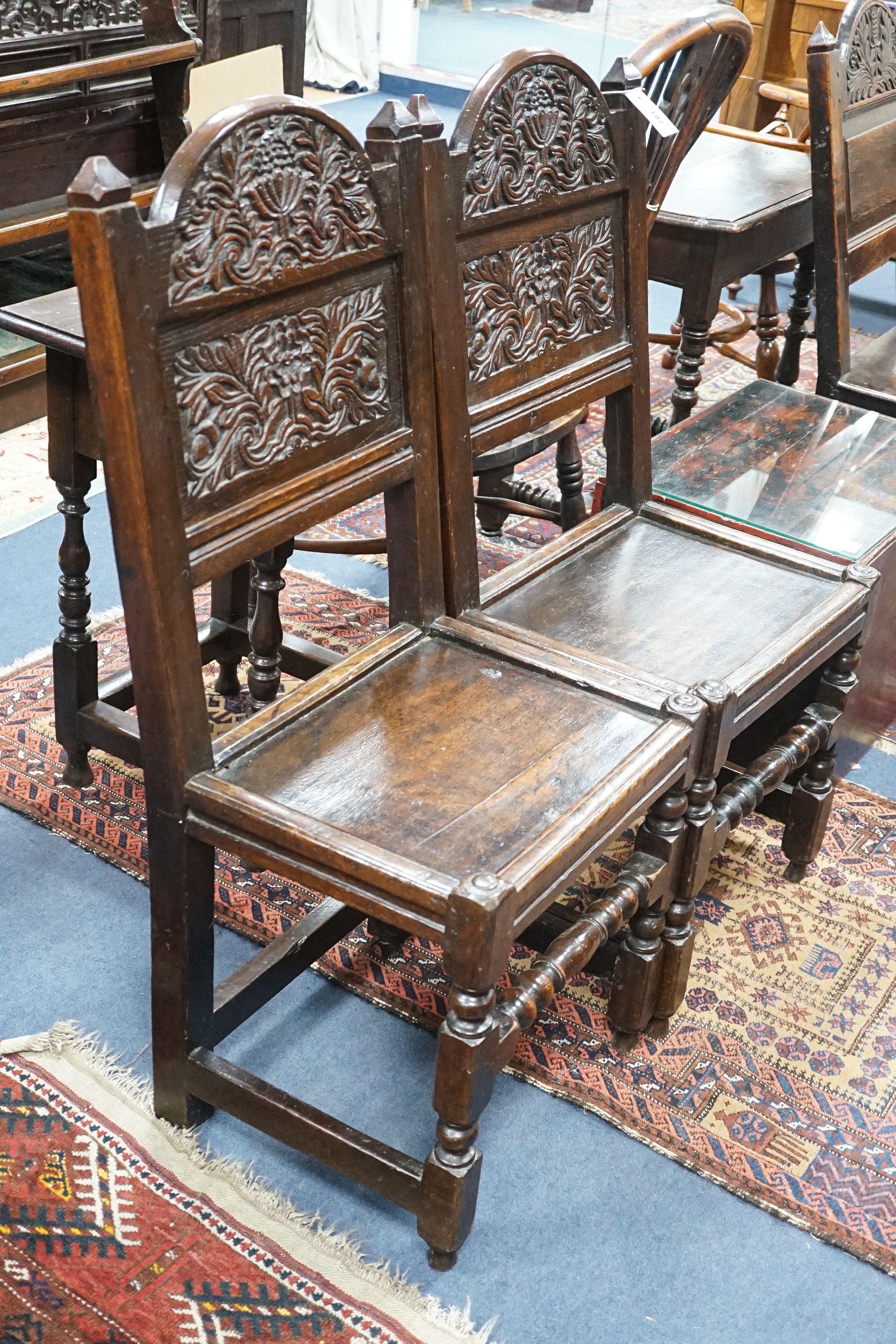 A pair of 17th century Lancashire carved oak side chairs, width 45cm, depth 39cm, height 101cm